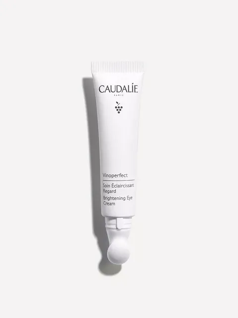Caudalie Vinoperfect Brightening Eye Cream tube on white background.