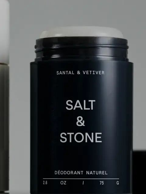 Black deodorant stick labelled "Salt & Stone", "Santal & Vetiver".