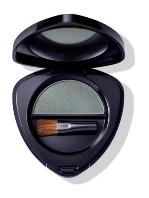 Open compact with green eyeshadow and small brush inside.