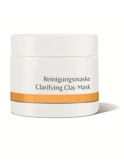 White jar labelled "Reinigungsmaske Clarifying Clay Mask" with orange stripe.