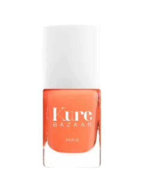 Kure Bazaar orange nail polish bottle with white cap.
