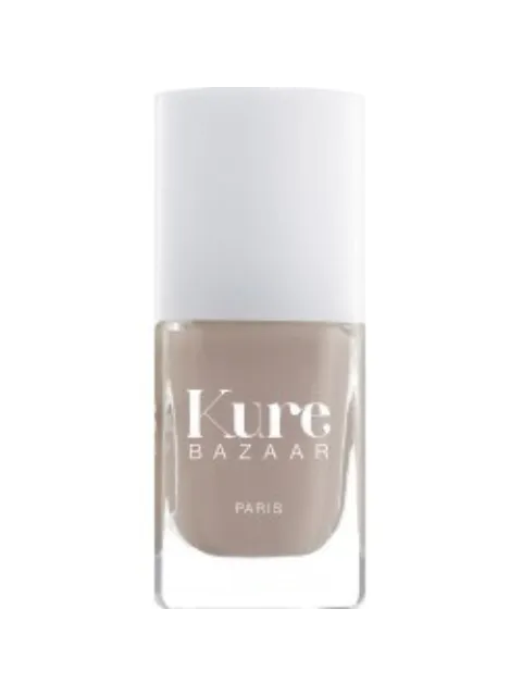 Kure Bazaar nail polish bottle with beige colour and white cap.