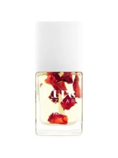 Clear nail polish bottle with red flower petals inside. White cap.