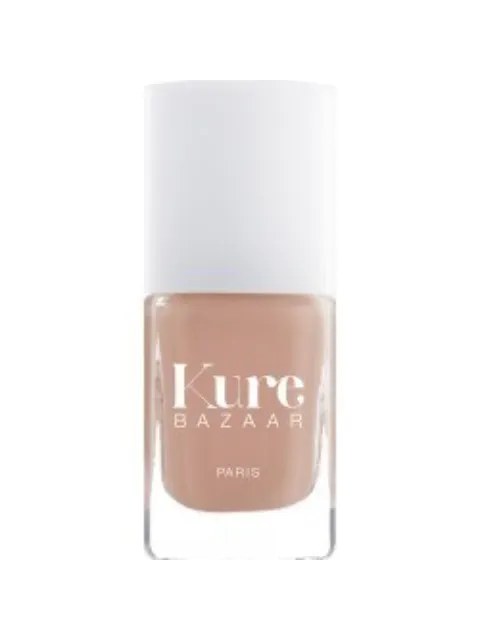Kure Bazaar nail polish bottle with beige colour and white cap.