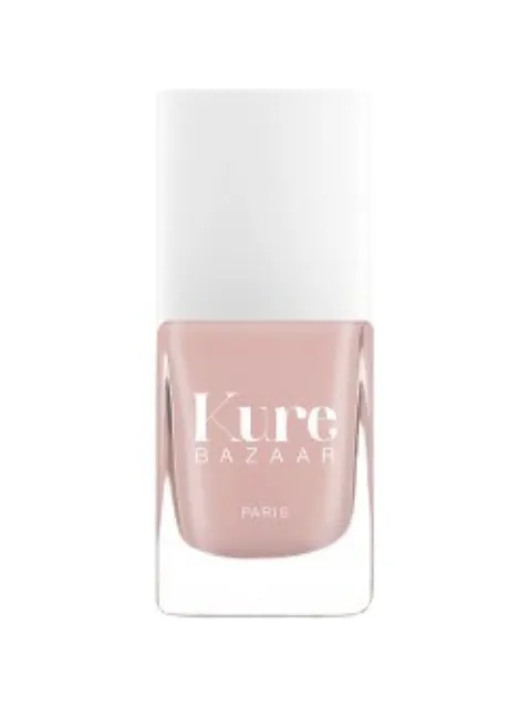 Kure Bazaar Paris nail polish in a light pink shade with a white cap.