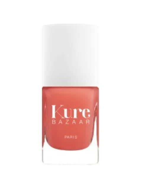 Kure Bazaar coral nail polish bottle with white cap.