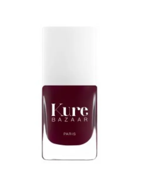Kure Bazaar nail polish bottle, dark red colour, white cap.