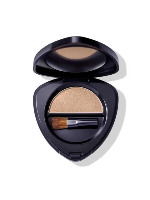 Open compact with beige powder and small brush inside.