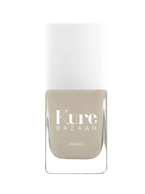 Kure Bazaar nail polish bottle with beige colour and white cap.