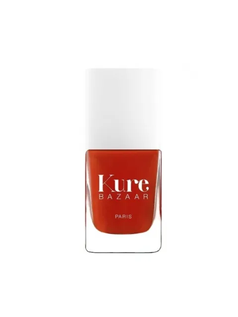 Kure Bazaar nail polish bottle with red-orange colour and white cap.