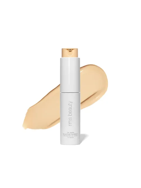 White bottle of rms beauty foundation with beige swatch behind.