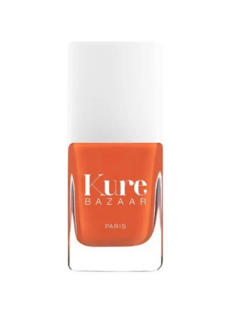 Orange nail polish bottle with "Kure Bazaar Paris" text.