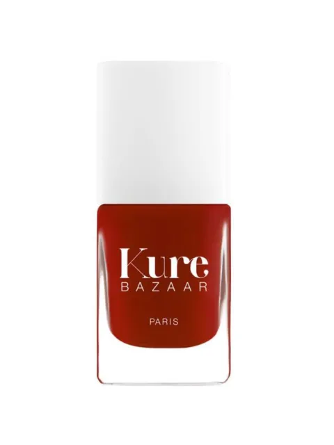 Red nail polish bottle with "Kure Bazaar Paris" text.