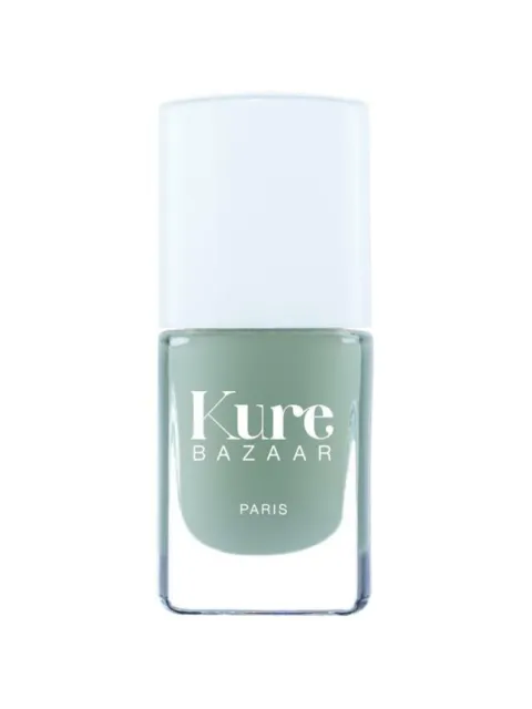 Green nail polish bottle with "Kure Bazaar Paris" text.
