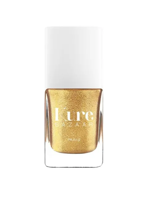 Gold nail polish bottle with white cap, labelled "Kure Bazaar Paris".