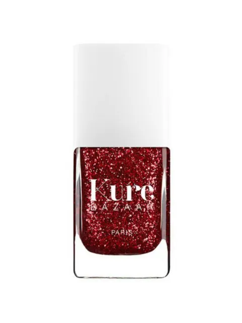 Kure Bazaar red glitter nail polish bottle with white cap.