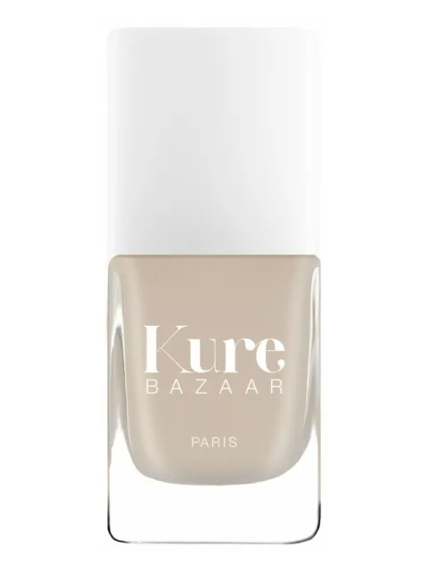 Kure Bazaar Paris nail polish in a beige shade with a white cap.