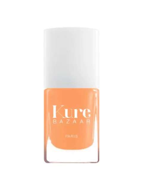 Kure Bazaar orange nail polish bottle with white cap.