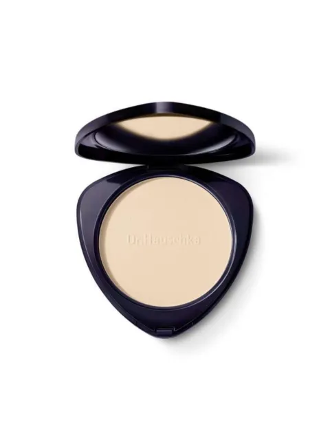Compact powder with "Dr. Hauschka" embossed, in a dark triangular case.