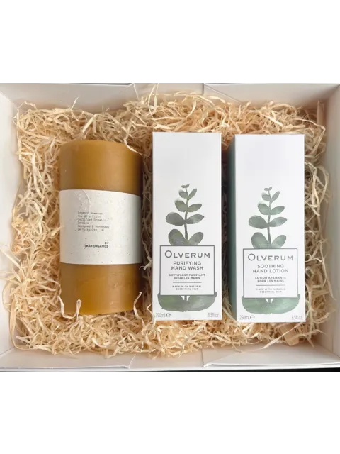 Gift box with candle, Olverum hand wash and lotion on straw bedding.