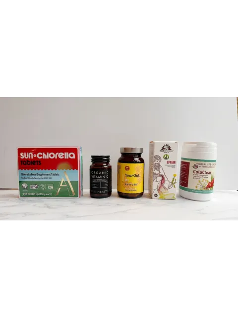 Five supplement bottles and boxes on a white surface, including Sun Chlorella and ColoClear.