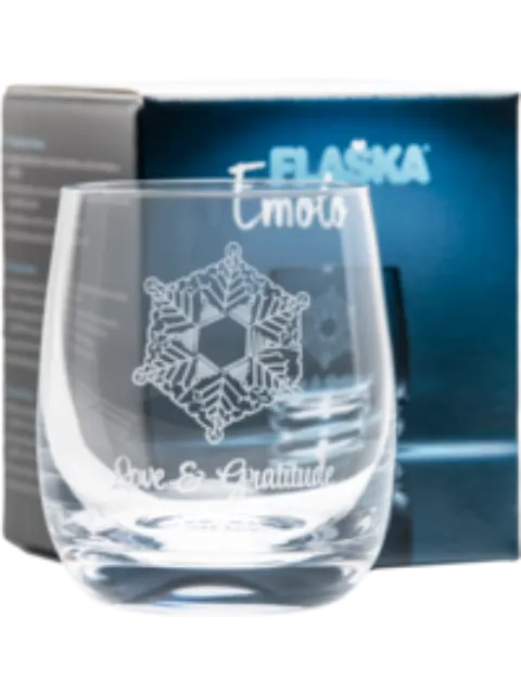 Glass with snowflake design, text "Emoto" and "Love & Gratitude", blue box in background.