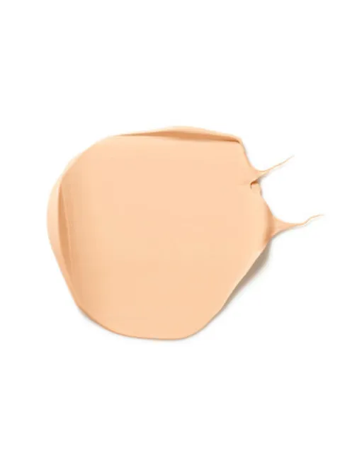 Beige skincare cream smear on white background.