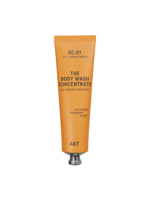 Orange tube of AKT body wash concentrate with citrus scents.