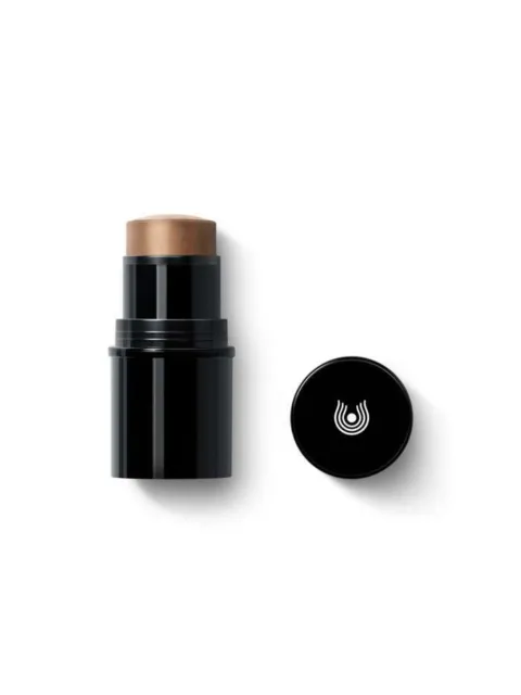 Black makeup stick with brown tip, cap beside it, white logo on cap.
