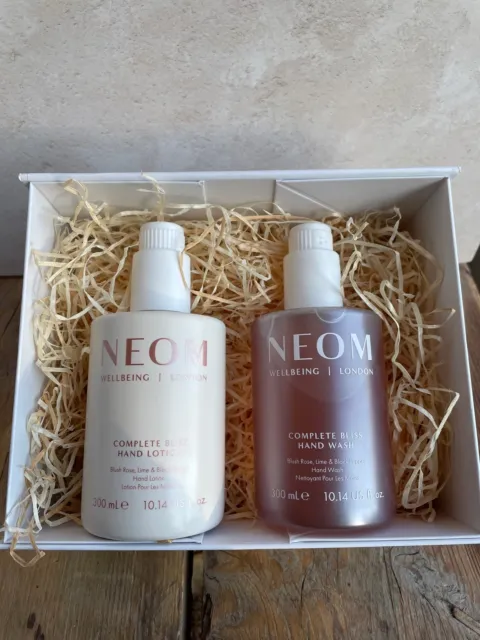 Neom hand lotion and wash set in a white box with straw filling.