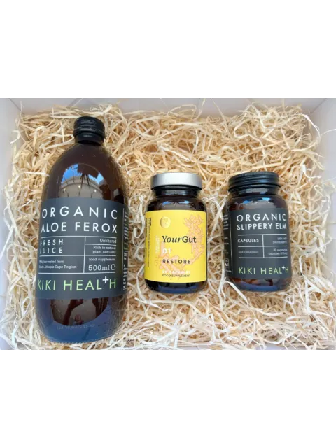Three Kiki Health supplements on straw: Aloe Ferox juice, YourGut Restore, Slippery Elm capsules.
