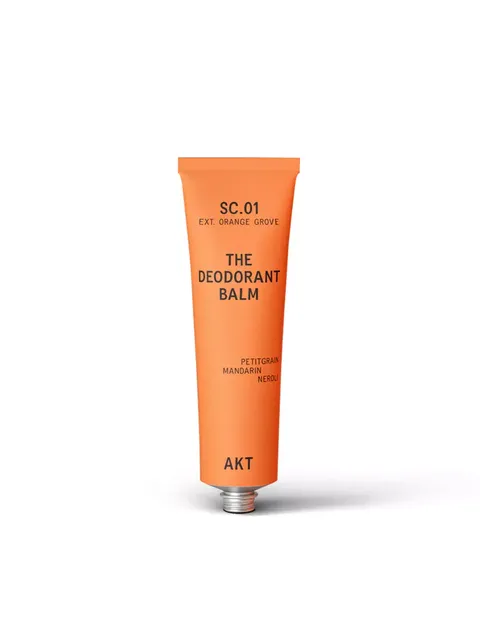 Orange tube of deodorant balm with text: SC.01, Orange Grove, Petitgrain, Mandarin, Neroli, AKT.