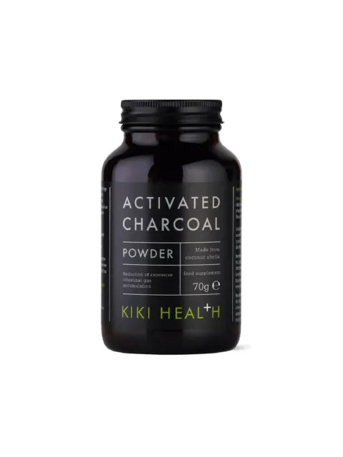 Black jar of Kiki Health activated charcoal powder, 70g, made from coconut shells.