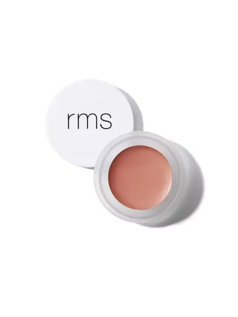 Open pot of peach-coloured cream with "rms" on the lid.