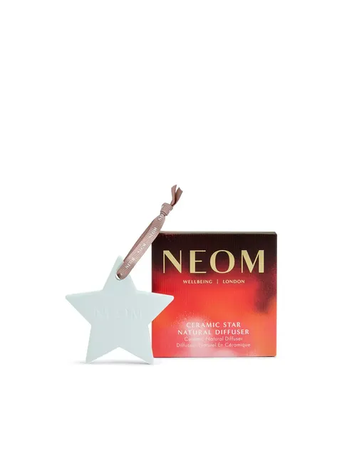 Ceramic star diffuser with ribbon beside NEOM branded box.