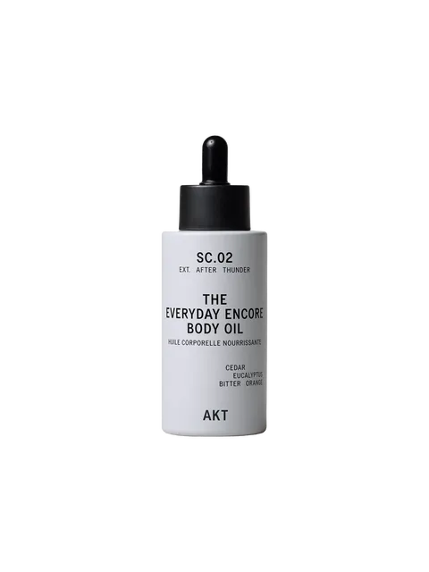 White bottle of AKT Everyday Encore Body Oil with dropper lid.