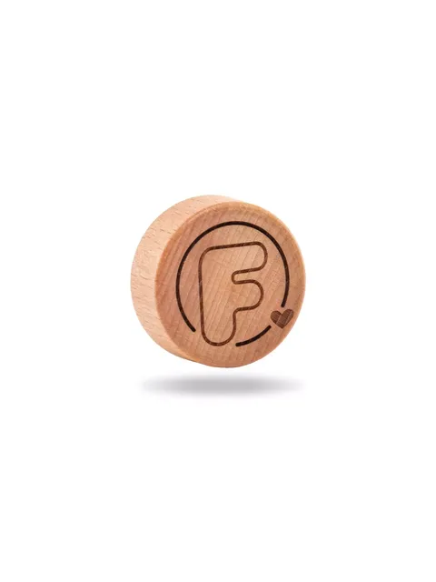 Wooden disc with engraved letter "F" and heart symbol.