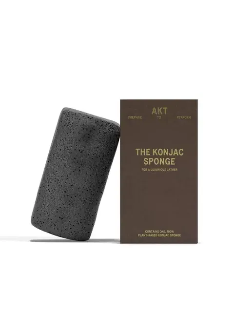 Black konjac sponge next to brown box labelled "The Konjac Sponge".