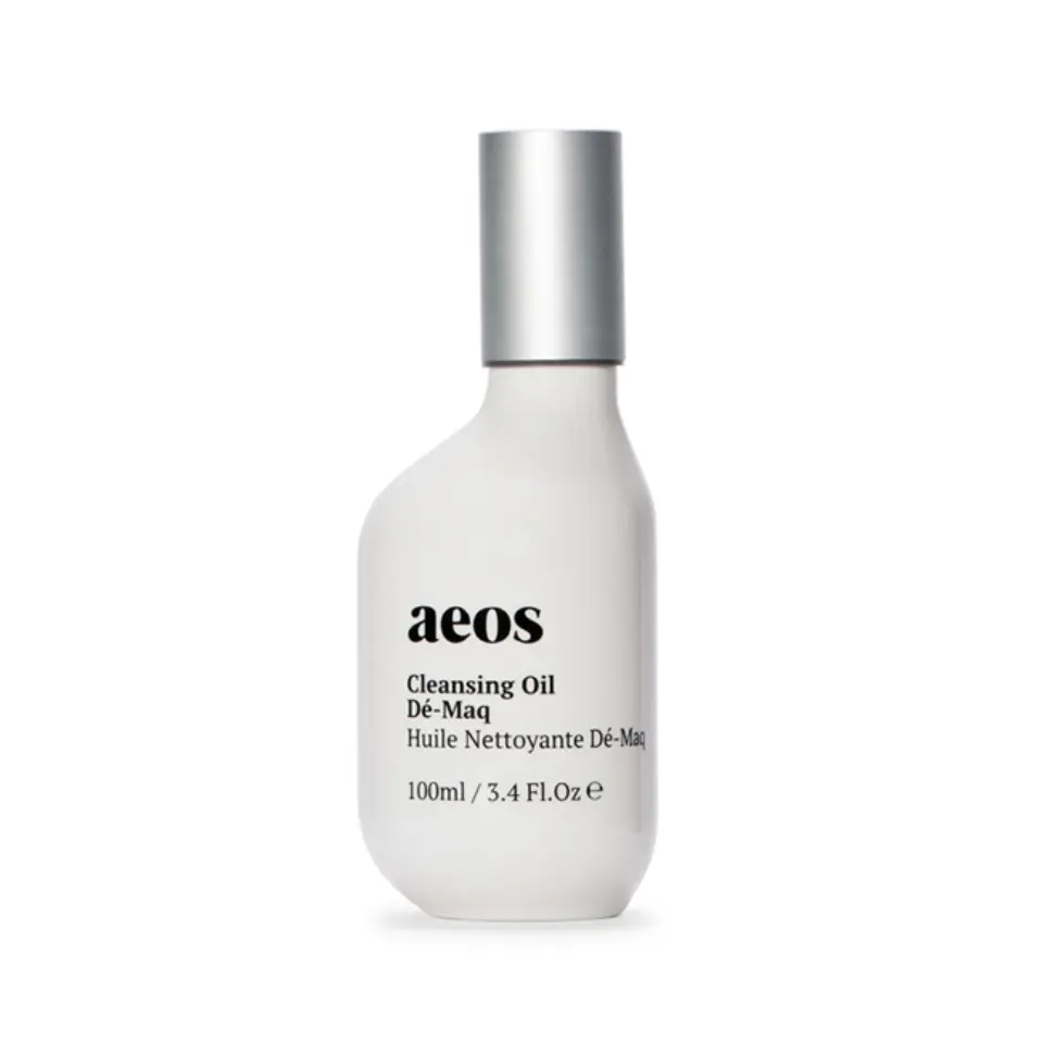 White bottle of aeos Cleansing Oil Dé-Maq, 100ml, with silver cap.