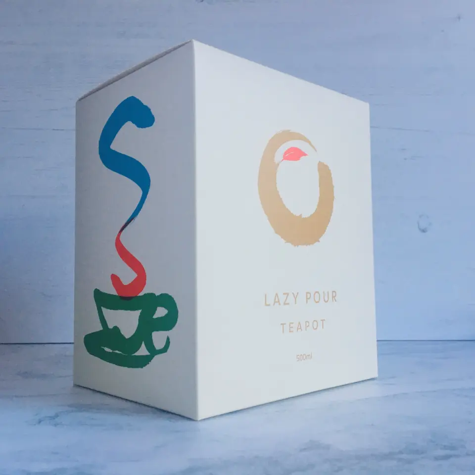 Box with "Lazy Pour Teapot 500ml" text and colourful cup design.
