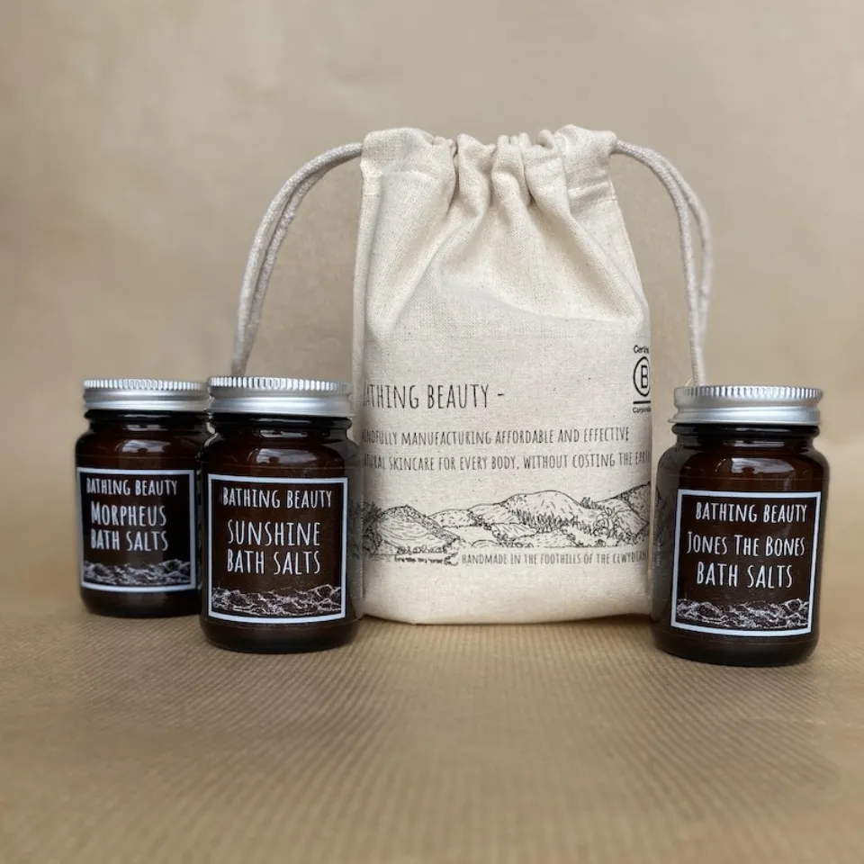 Three jars of Bathing Beauty bath salts with a drawstring bag.