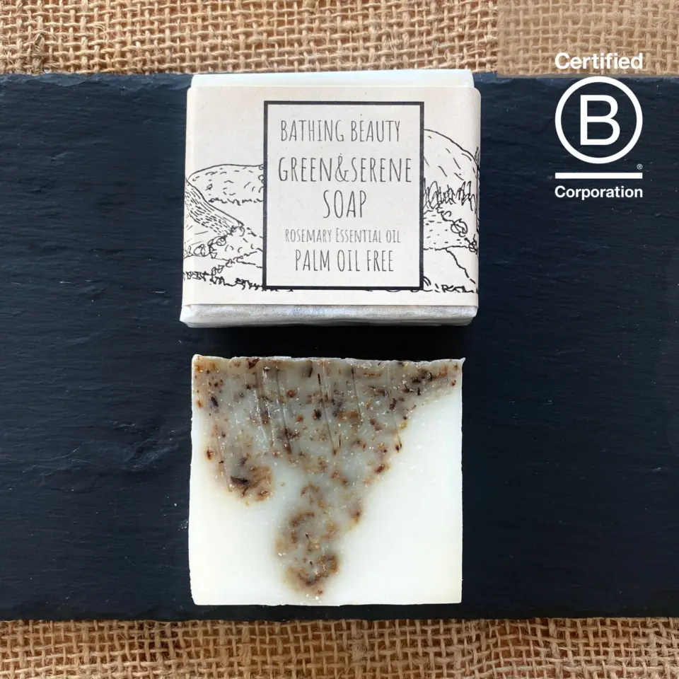 Soap bar and packaging on slate. Text: Bathing Beauty Green & Serene, palm oil free.