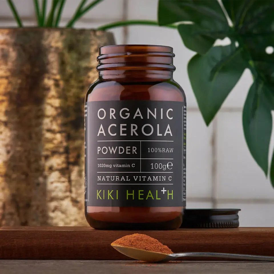 Brown jar of organic acerola powder, 100g, with a spoonful of powder in front.
