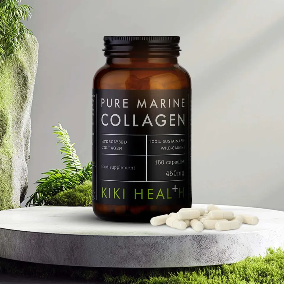 Brown bottle of Pure Marine Collagen capsules on a stone surface with greenery.
