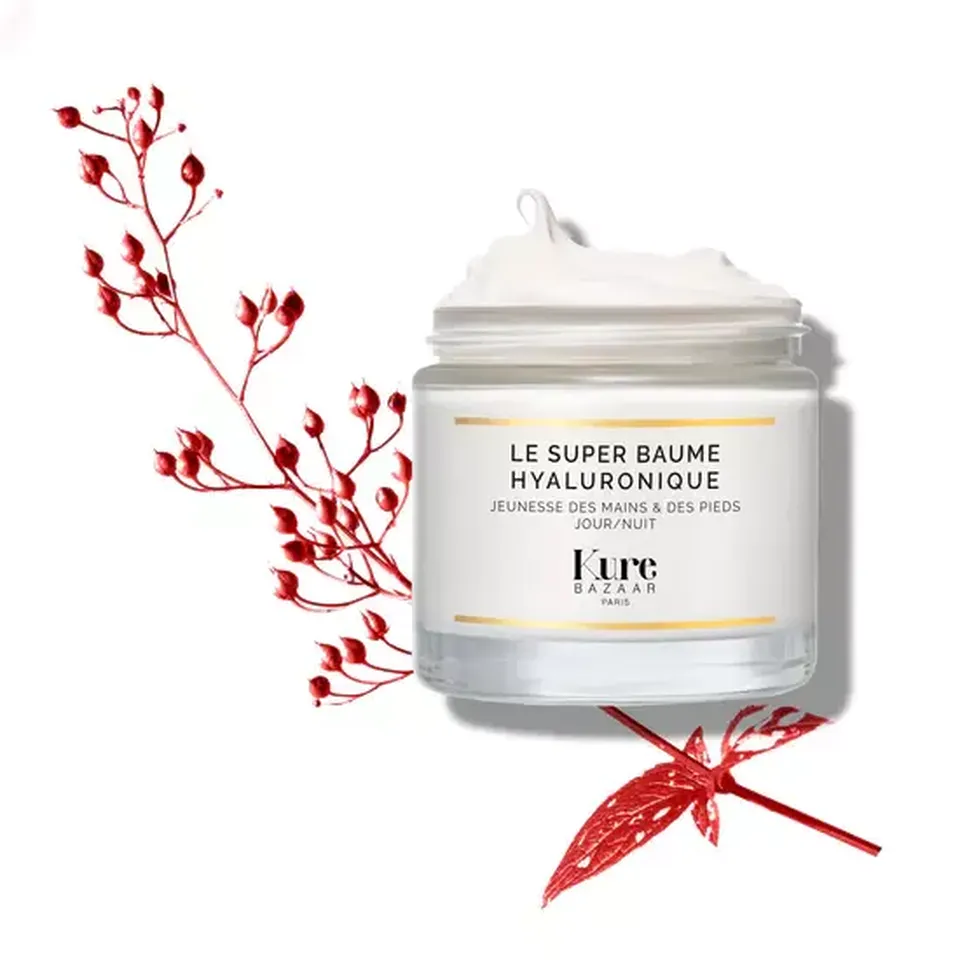 Kure Bazaar Le Super Baume Hyaluronique jar with red botanical accents.
