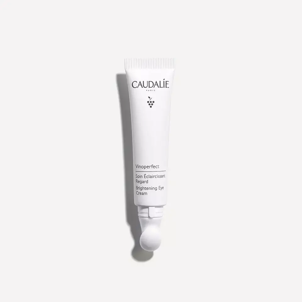 Caudalie Vinoperfect Brightening Eye Cream tube on white background.