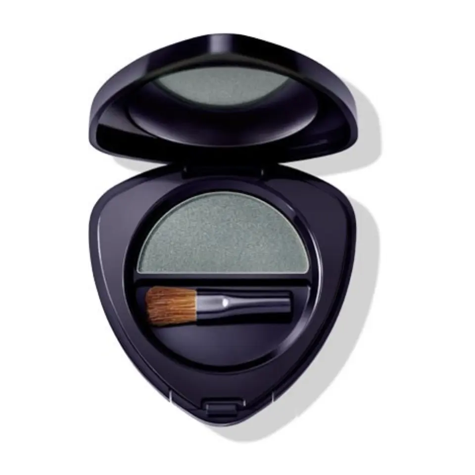 Open compact with green eyeshadow and small brush inside.