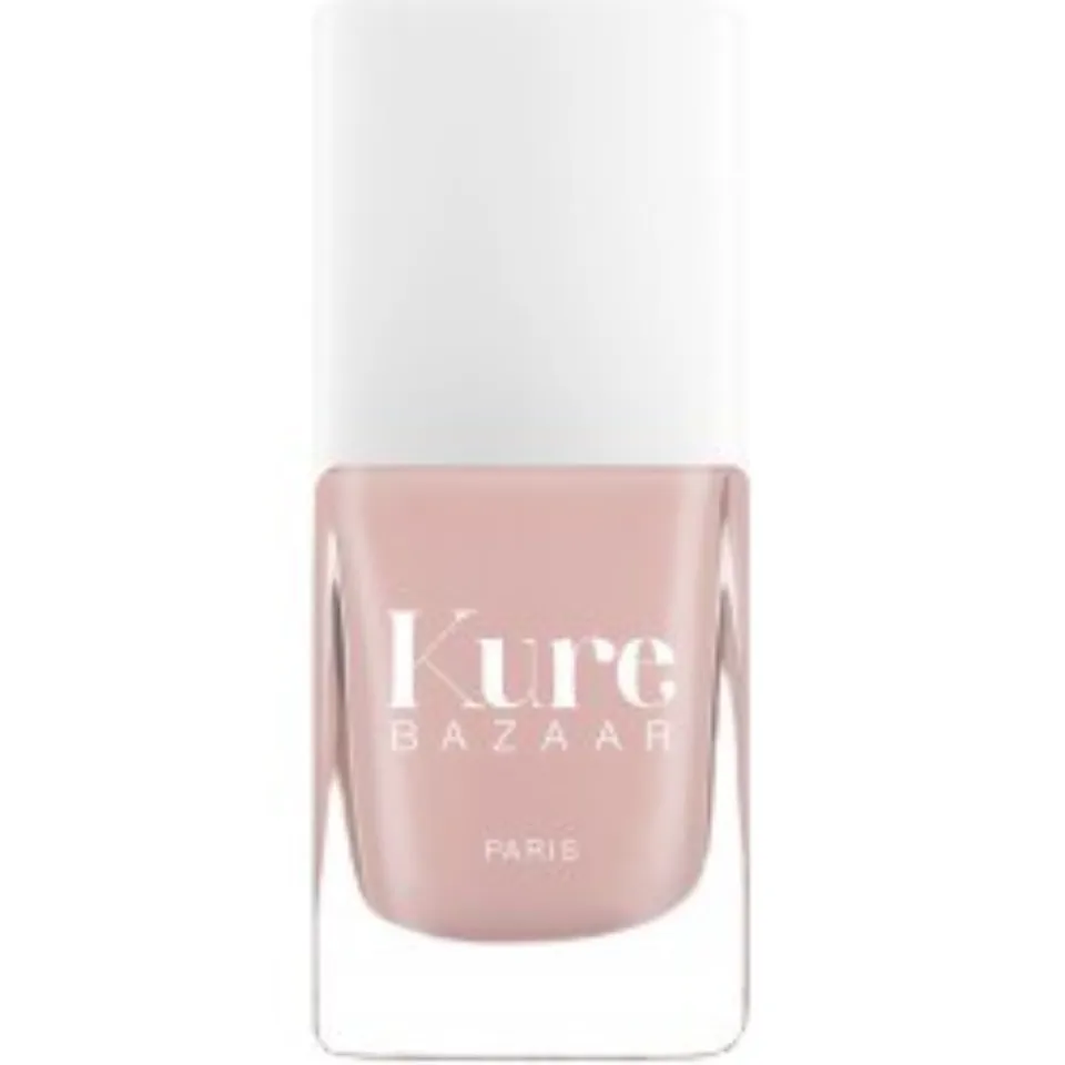 Kure Bazaar Paris nail polish in a light pink shade with a white cap.