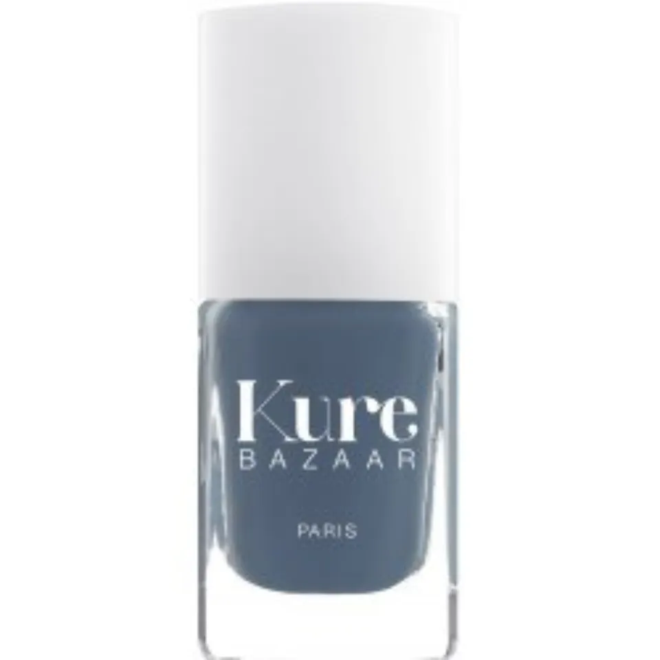 Kure Bazaar nail polish bottle, grey-blue shade, white cap.