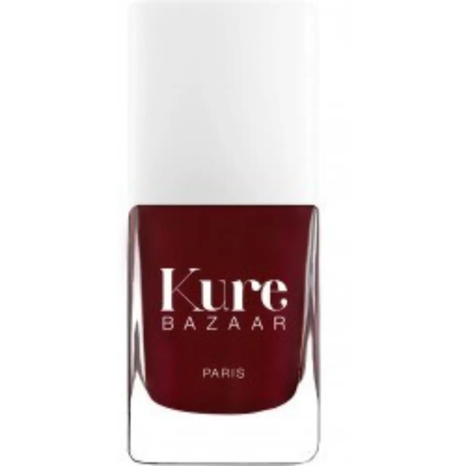 Kure Bazaar nail polish bottle, deep red colour, white cap, text "Kure Bazaar Paris".